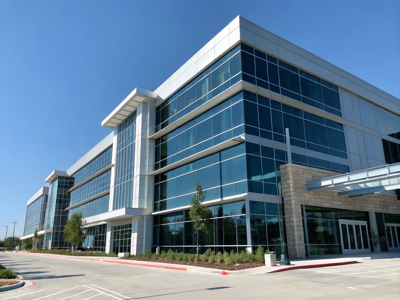 A modern commercial building with glass windows and a flat roof, taken during daylight. The image should convey professionalism and structural integrity.